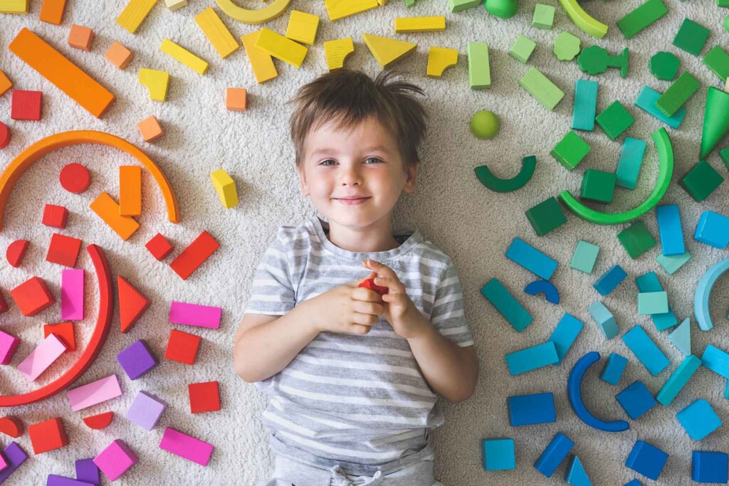 Child smiling, at Montessori School with blocks, Eagan Montessori Academy open house