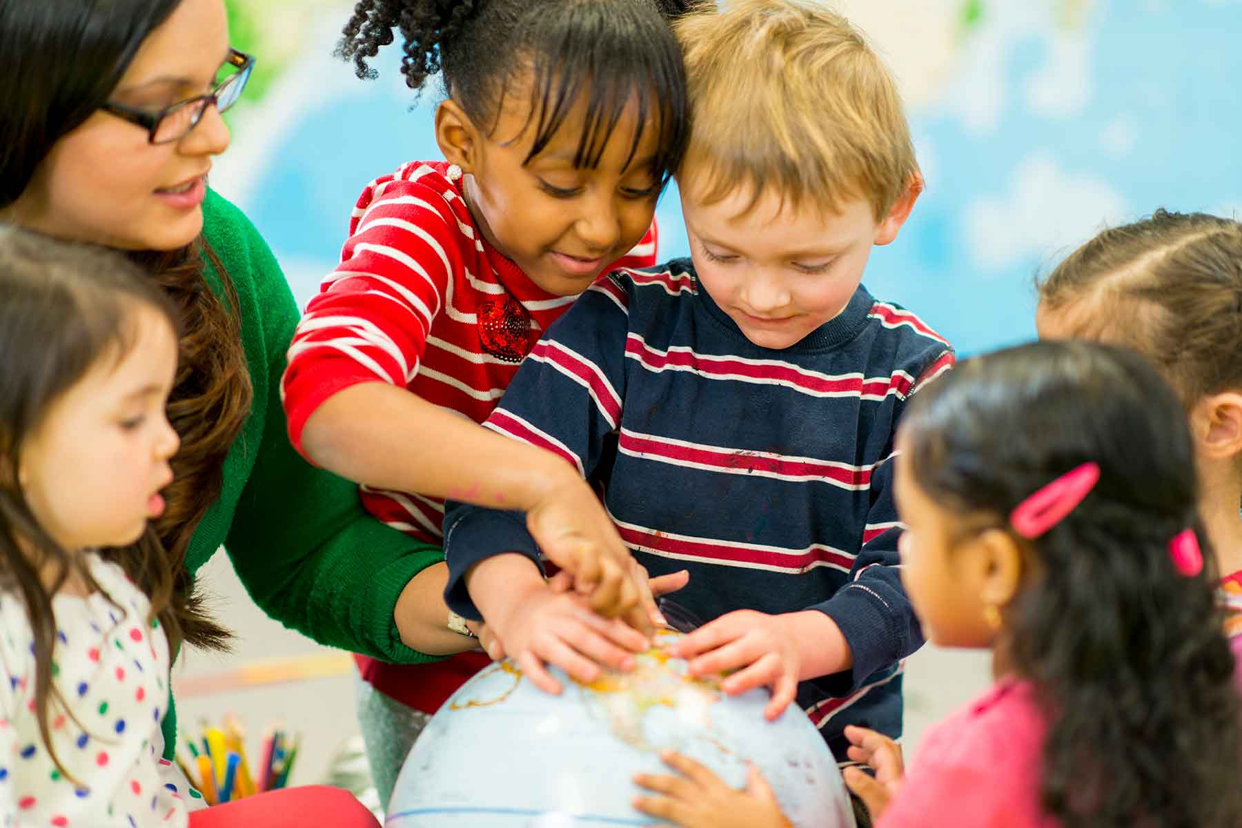 back-to-school-montessori-amb Back to School Montessori, children and teacher studying the globe